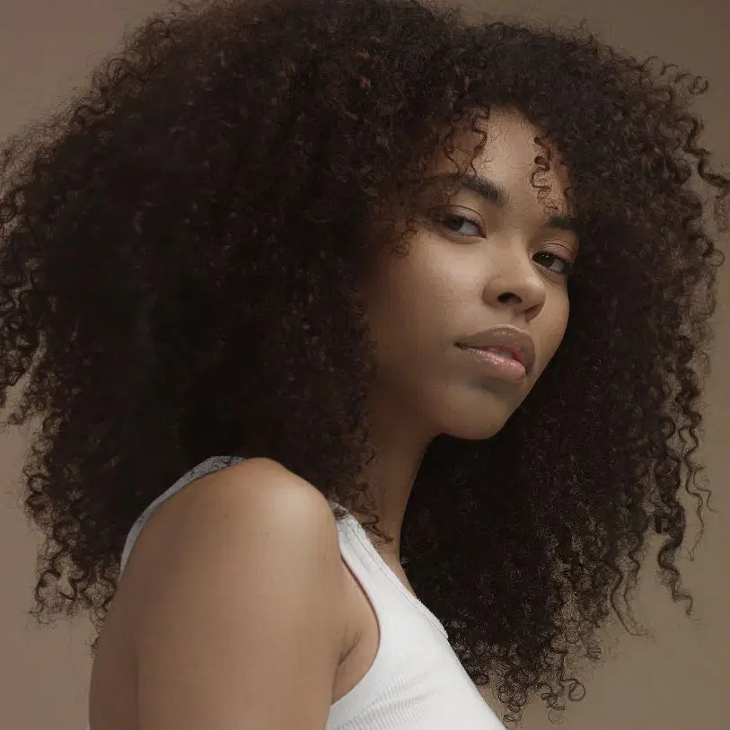 Mulher de cabelo cacheado preto com corte de cabelo em camadas