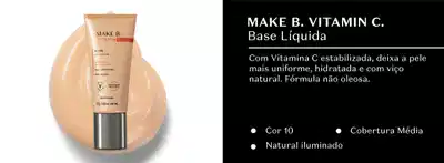 Tubo em tom de laranja com tampa prata de base líquida Make B. Vitamin C. em fundo branco e, ao lado, em fundo preto, letras brancas falando sobre o produto.