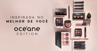 A imagem mostra uma variedade de produtos de maquiagem da marca Oceane, incluindo paletas de sombras, batons e delineadores, dispostos sobre um fundo claro.