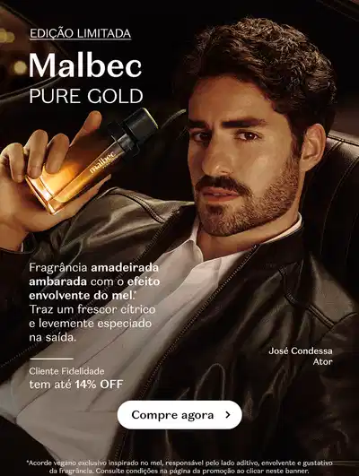 Homem com barba segurando um frasco de Malbec Pure Gold, sobre fundo escuro, com letras na cor branca.