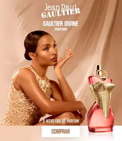 O banner mostra uma modelo feminina com maquiagem suave, usando um vestido dourado brilhante, segurando um frasco de fragrância elegante. O texto promove o novo perfume "Gaultier Divine" da marca Jean Paul Gaultier.