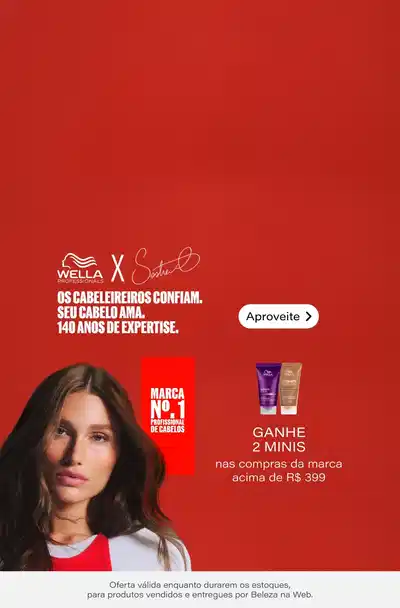 Campanha Wella x Stella com mulher de cabelos longos e lisos em fundo vermelho. Texto: "Os cabeleireiros confiam. Seu cabelo ama. 140 anos de expertise." Botão "Aproveite". À direita, marca Wella Professional de Cabelos. Oferta: Ganhe Nécessaire nas compras das linhas Ultimates acima de R$299,00. Mais 2 minis nas compras da marca acima de R$399,00. Nota: