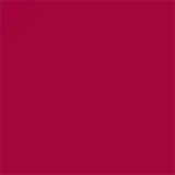A imagem mostra um batom tipo bala, rosa, com a tampa ao lado. A embalagem é preta e prata com o logo da marca em preto.