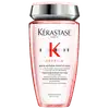 Frasco de shampoo da marca Kérastase Paris, da linha Genesis, com embalagem rosa e prata. O rótulo apresenta o nome da marca, da linha e informações sobre o produto, que é um shampoo fortificante anti-queda.