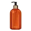 Vidro laranja de tampa dosadora preta com detalhe e letras douradas contendo 400ml de sabonete líquido Casa 214 Vanilla Sublime.