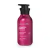Embalagem pump de 400ml de creme corporal perfumado da marca Nativa SPA Orquídea Lumière, com cor rosa vibrante e tampa preta, com informações sobre o produto escritas em branco no rótulo.