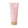 Embalagem plástica tubular rosa claro com tampa redonda dourada na base. Rótulo com o nome do produto e a marca Eudora em letras douradas. Volume de 200 ml indicado na embalagem.