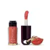 O produto de beleza Eudora Make apresenta um frasco de tinta labial na cor coral e um batom vermelho em embalagem preta com detalhes dourados, além de um pingente em formato de lábios.