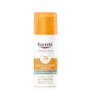Frasco de protetor solar Eucerin Oil Control Tinted com FPS 70, embalagem laranja e branca, rótulo com informações sobre o produto e sua tecnologia avançada.