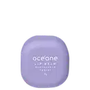 Embalagem compacta arredondada de plástico na cor lilás claro. Texto branco na superfície indica "océane LIP BALM hidratante labial" e o peso líquido de 7g. Design minimalista e clean, com foco no produto de cuidado labial hidratante.