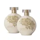 Imagem de dois frascos de item de perfumaria da marca Floratta, com embalagem arredondada em tom branco e detalhes florais dourados, exibindo o texto "Simple Love" no rótulo.