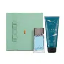 Caixa de presente verde-clara com fita no mesmo tom e o Boticário em dourado. Ao lado, vemos um frasco de vidro transparente com líquido azul-claro da fragrância "CLASH" e tubo de hidratante desodorante corporal na cor azul-escuro da mesma linha Clash.
