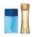 Imagem de dois itens de perfumaria O Boticário: um vidro azul-claro com tampa azul-marinho da marca Quasar Rush e um vidro transparente, com líquido bege e tampa dourada em forma de flor da marca Linda.