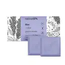 Caixa branca com faixa lilás e ilustrações na cor preta ao lado de dois sabonetes em barra quadrados na cor lilás da marca Nativa SPA Lilac, contendo 90g cada um.