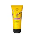 Frasco amarelo com tampa preta e ilustrações de palitos de madeira com mel e folhagens contendo 170ml de condicionador vegano Mel Cuide-se Bem Feira.