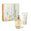 Caixa com ilustração de flores e folhagens coloridas, acompanhada de dois itens da marca L'eau de Lily: vidro oval com líquido bege e tampa dourada de desodorante colônia e frasco branco com tampa bege e letras douradas de creme de mãos.