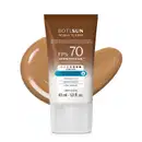 Frasco de 40ml de protetor solar facial com cor 4.0 FPS 70 Boti.Sun em embalagem marrom e branca e rótulo com letras brancas contendo informações sobre o produto. Ele está à frente de uma quantidade do produto mostrando textura e tonalidade bege escuro.