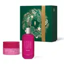 Caixa verde com detalhes dourados contendo um frasco de perfume rosa e um pote de creme corporal rosa da marca Egeo, com rótulos indicando os produtos "Dolce" e "Egeo".