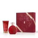 Caixa de presente de cor vinho com um grande coração ilustrado detalhes de temática celestial. Ao lado, um frasco vermelho opaco com relevo floral e tampa transparente de desodorante colônia Floratta Red e bisnaga de loção corporal vermelha da mesma linha