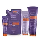 A imagem mostra um kit com quatro produtos, uma bisnaga pequena de leave-in, um refil de máscara capilar, uma bisnaga de condicionador e outra de shampoo. Todos com embalagem roxa, letras brancas, roxas e laranjas.