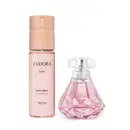 Desodorante Colônia 75ml com frasco que lembra um diamante e  Body Spray 100ml com frasco cilíndrico. Cores predominantes são o rosa e rosé.