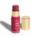 O produto apresentado é um blush stick da linha Niina Secrets da marca Eudora. Possui uma embalagem rosa com detalhes dourados, incluindo o nome da marca e da linha. O produto tem formato cilíndrico e tampa dourada na parte superior.