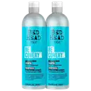 Dois frascos de shampoo TIGI Bed Head Recovery, com embalagem branca e azul, contendo 750 ml cada. O rótulo destaca o nome da linha "Recovery" e a promessa de "Moisture Rush" para cabelos secos e danificados.