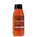 Frasco de shampoo de geléia real e proteína da marca Mise en Scène, com 200 ml de capacidade. O recipiente possui uma superfície laranja brilhante, com rótulo em preto e marrom destacando os ingredientes principais.