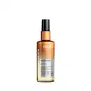 Frasco de óleo capilar nutritivo TRUSS, com embalagem tipo spray nas cores laranja bronze no topo e degradê amarelo embaixo. Títulos em branco sobre o frasco e rótulo com informações em preto sob fundo prata na parte médio inferior do frasco.
