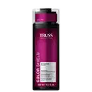 Frasco de item de perfumaria da marca Truss Professional, na cor rosa escuro, com rótulo branco contendo o nome da marca e informações sobre o produto, que parece ser um xampu para proteção da cor.