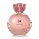 frasco de item de perfumaria da marca Liz Sublime, com embalagem de vidro arredondada rosa-claro facetado e nome da marca em vermelho escuro gravado no vidro. A tampa é em acrílico transparente e permite ver a tampa borrifadora de tom metálico rosa.