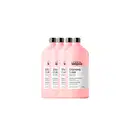 Quatro frascos de shampoo da linha Vitamino Color da L'Oréal Professionnel, com embalagem rosa e rótulos indicando a série e o tipo de produto para cabelos coloridos.