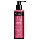 Frasco de produto de beleza da marca Principia, com embalagem rosa e preta, contendo informações sobre o produto e seus ingredientes. O frasco possui um rótulo com o site e contato da empresa.