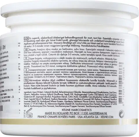 Frasco branco de produto de beleza da marca Keune, com rótulo informativo sobre os ingredientes e instruções de uso. O recipiente possui uma tampa arredondada e a embalagem apresenta o nome da marca e informações de contato.
