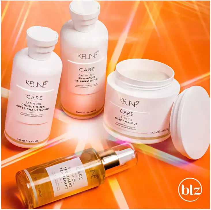 Produtos de cuidados capilares da marca Keune em um ambiente vibrante de cores quentes, incluindo shampoo, condicionador e máscara de tratamento, sugerindo um contexto de cuidados com a beleza e saúde dos cabelos.