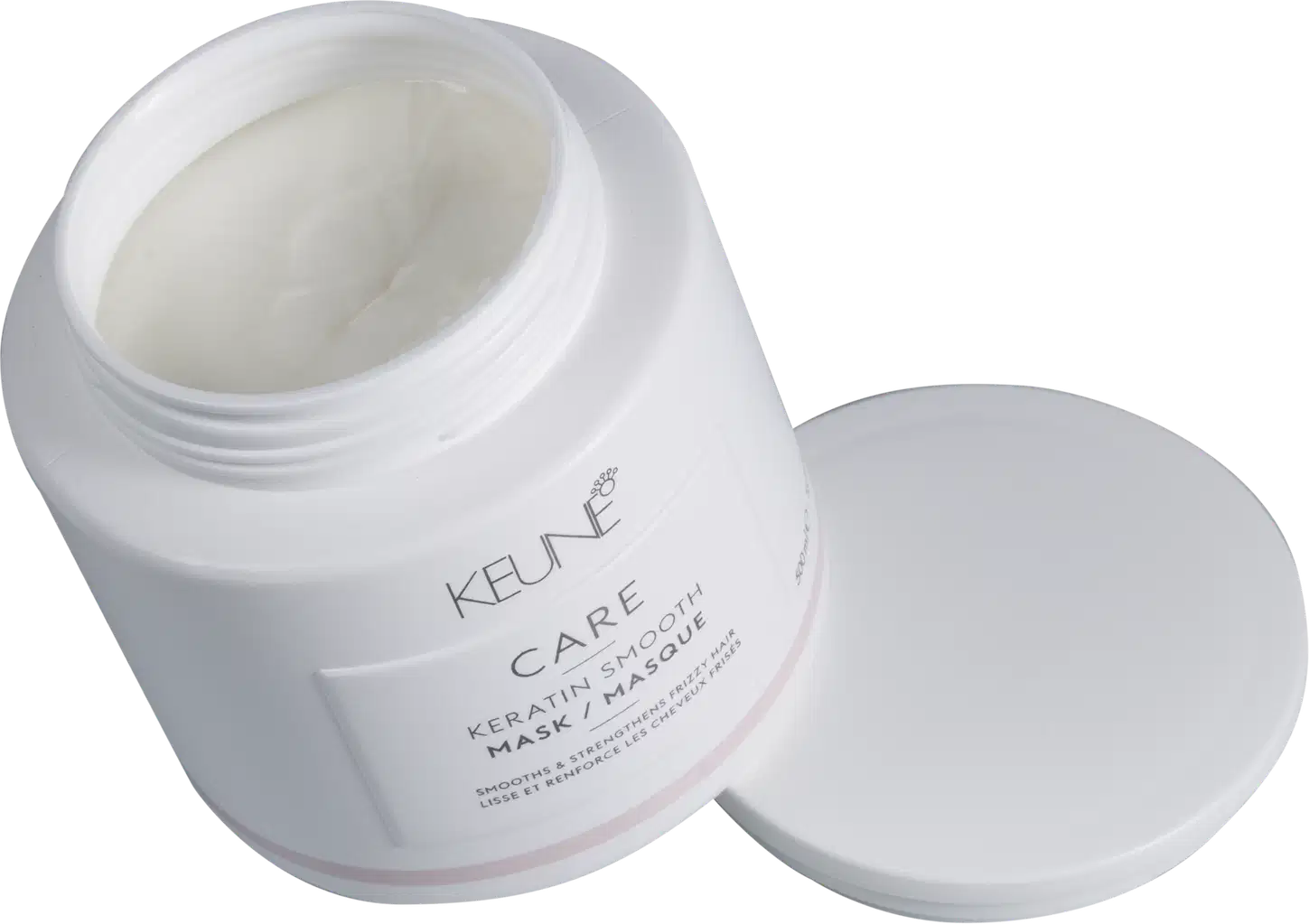 Recipiente branco de produto de tratamento capilar da marca Keune, com rótulo destacado em fundo preto, sugerindo um ambiente de cuidados pessoais e beleza.