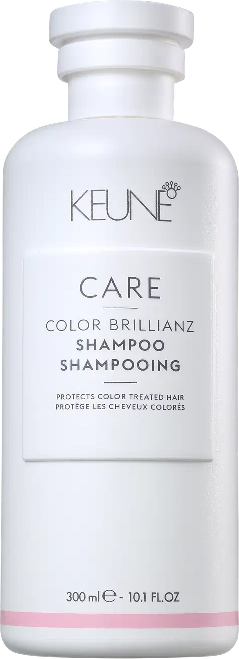 Frasco branco da linha Care da Keune, contendo Shampoo Color Brillianz para proteção de cabelos coloridos. Rótulo com nome do produto e informações sobre sua função de proteger a cor dos cabelos.