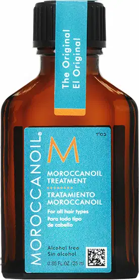 Frasco de óleo tratamento capilar Moroccanoil, com embalagem de vidro âmbar e rótulo azul turquesa. Apresenta informações sobre o produto, como "Tratamento Moroccanoil" e "Para todo tipo de cabelo".