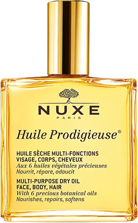 Frasco dourado de óleo multiuso da marca Nuxe, com rótulo em preto e amarelo indicando o nome "Huile Prodigieuse" e a descrição do produto como um óleo seco multifuncional para rosto, corpo e cabelos.