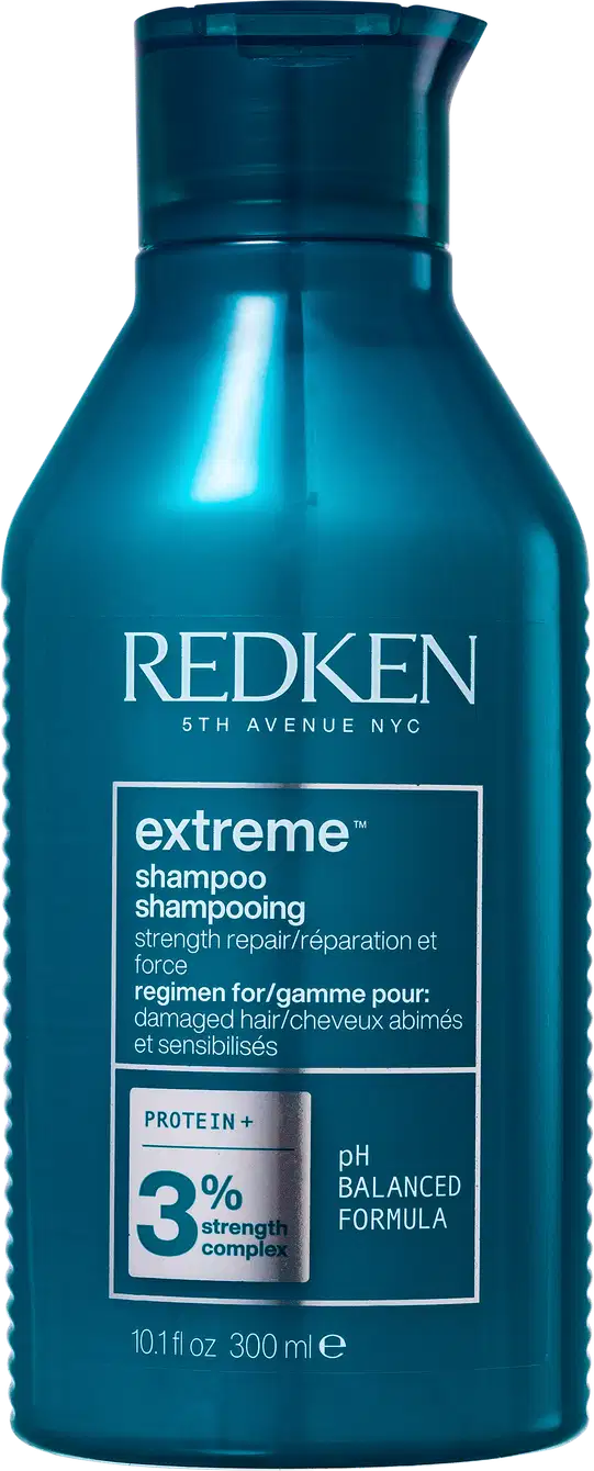 Frasco de shampoo Redken Extreme, com fórmula pH balanceada, contendo 3% de complexo de proteína, para cabelos danificados. Embalagem de 300 ml na cor azul escuro.
