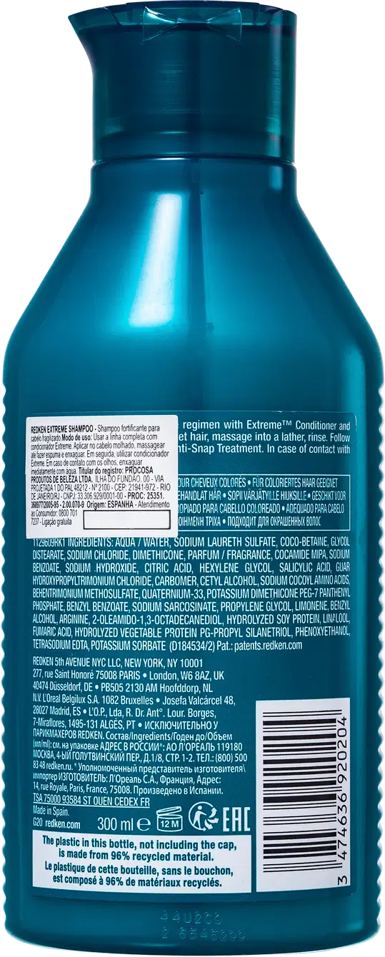 Frasco de shampoo Redken Extreme de 300 ml, com embalagem de plástico azul-esverdeado brilhante. O rótulo apresenta informações sobre o produto e sua composição.