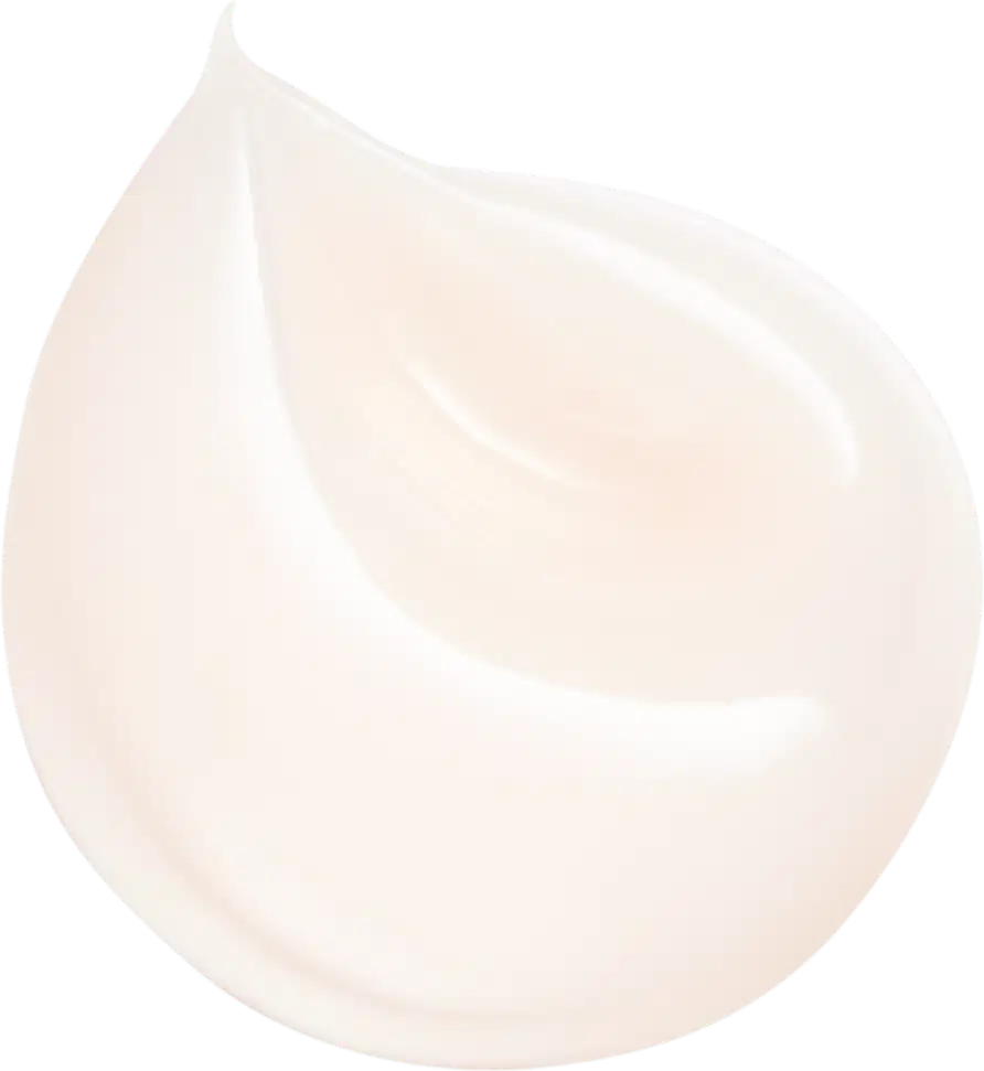 Na imagem, o creme facial está depositado em uma superfície branca, a fim de evidenciar a sua textura cremosa e viçosa.