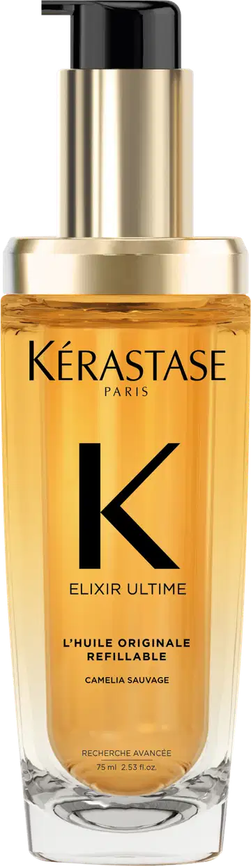 A imagem mostra o óleo capilar da marca Kérastase. O frasco é transparente, permitindo ver o líquido dourado dentro. O frasco tem um formato cilíndrico e uma bomba dosadora preta no topo. O rótulo apresenta letras pretas sobre um fundo dourado.