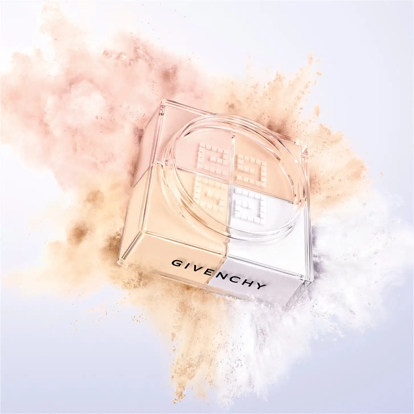 A imagem mostra a embalagem do pó solto e ao redor tem uma explosão das cores do pó, representando o poder e arte de givenchy.