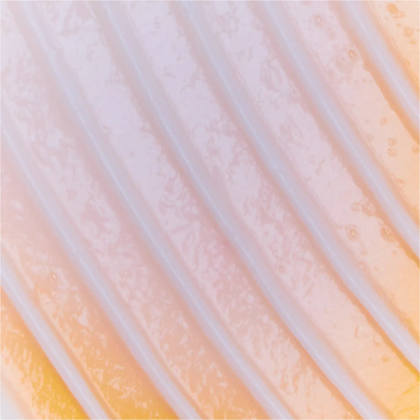 A textura apresenta uma aparência suave e sedosa, com tonalidades que variam do rosa pálido ao laranja claro, criando um efeito sutil e delicado.