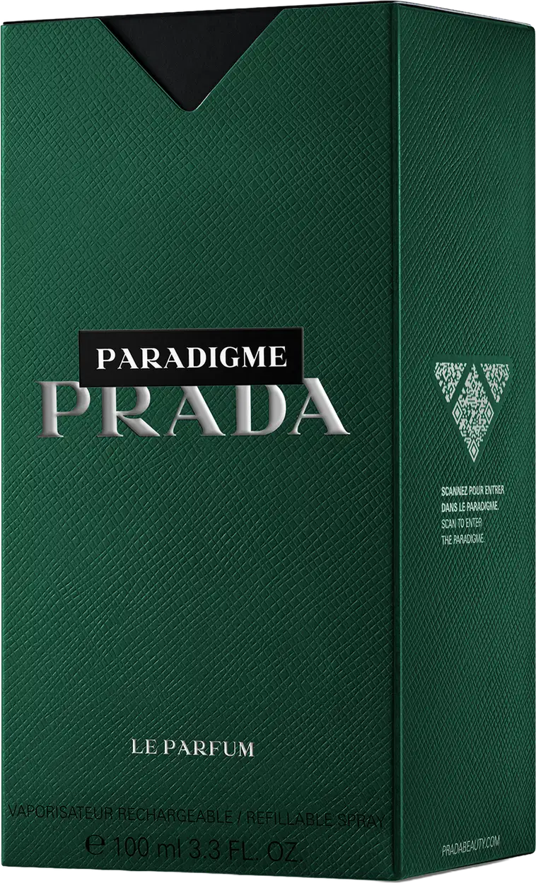 Caixa verde escura com o logotipo da Prada em branco e prata, contendo um frasco de perfume Paradigme da marca. A embalagem apresenta uma textura de couro sintético e o rótulo indica que se trata de um "Le Parfum" com 100 ml de conteúdo.