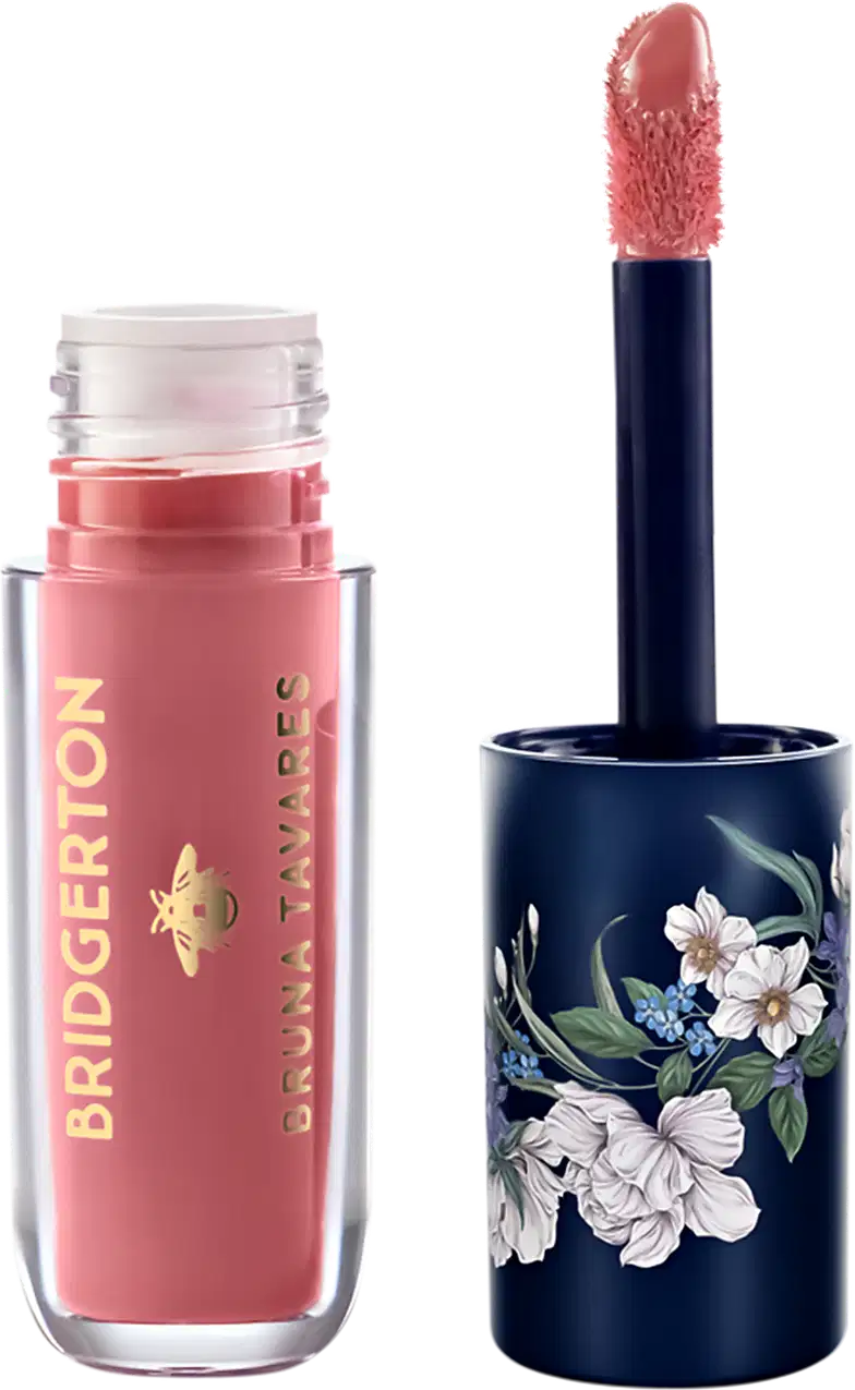 Embalagem de item de maquiagem da marca Bruna Tavares em tom de rosa, com aplicador de espuma, e tampa decorada com flores em fundo azul escuro.