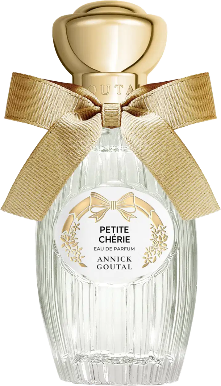 Eau de Parfum Petite Chérie da Annick Goutal em frasco de cristal com tampa dourada em formato de cúpula. Embalagem decorada com laço de fita bege e rótulo circular com detalhes florais dourados.