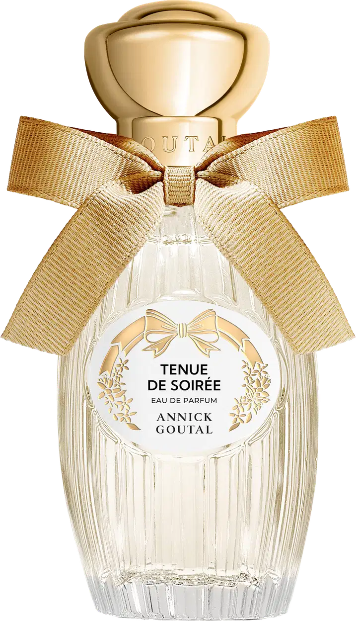 Eau de Parfum Tenue de Soirée da Annick Goutal em frasco de cristal transparente com tampa dourada esférica. Apresenta laço de fita bege e rótulo circular branco com detalhes florais dourados.