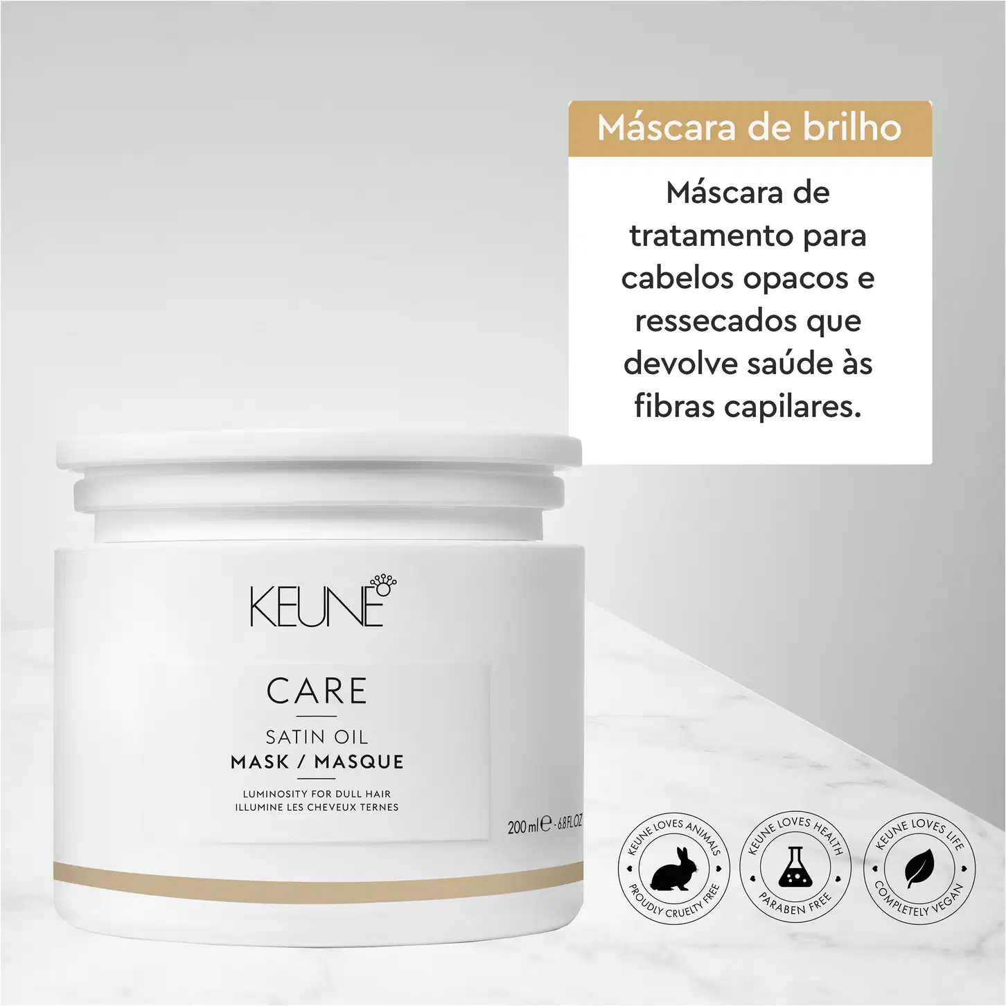 Embalagem branca de máscara de tratamento para cabelos opacos e ressecados da marca Keune, com rótulo em português indicando que o produto devolve saúde às fibras capilares. Frasco de 200ml com informações sobre os benefícios do produto.